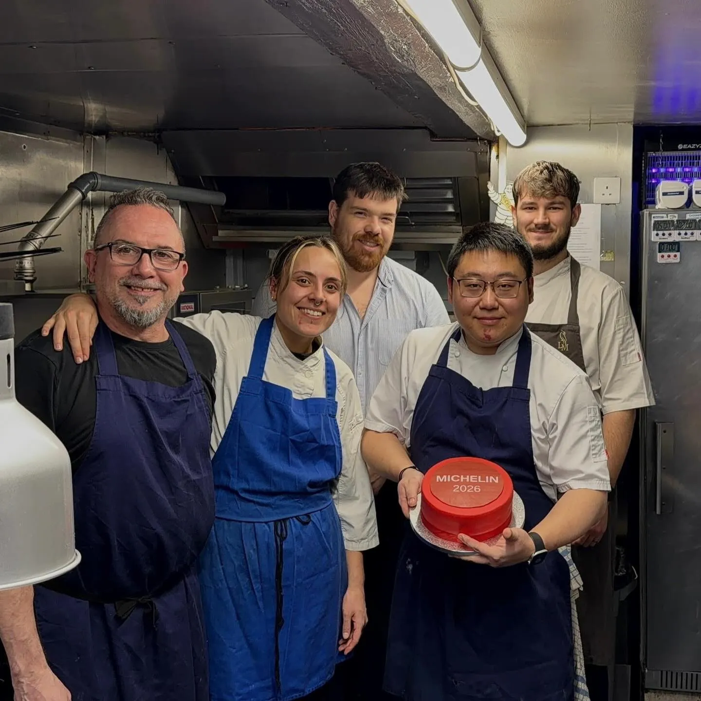 The kitchen team holding the Michelin 2026 disc