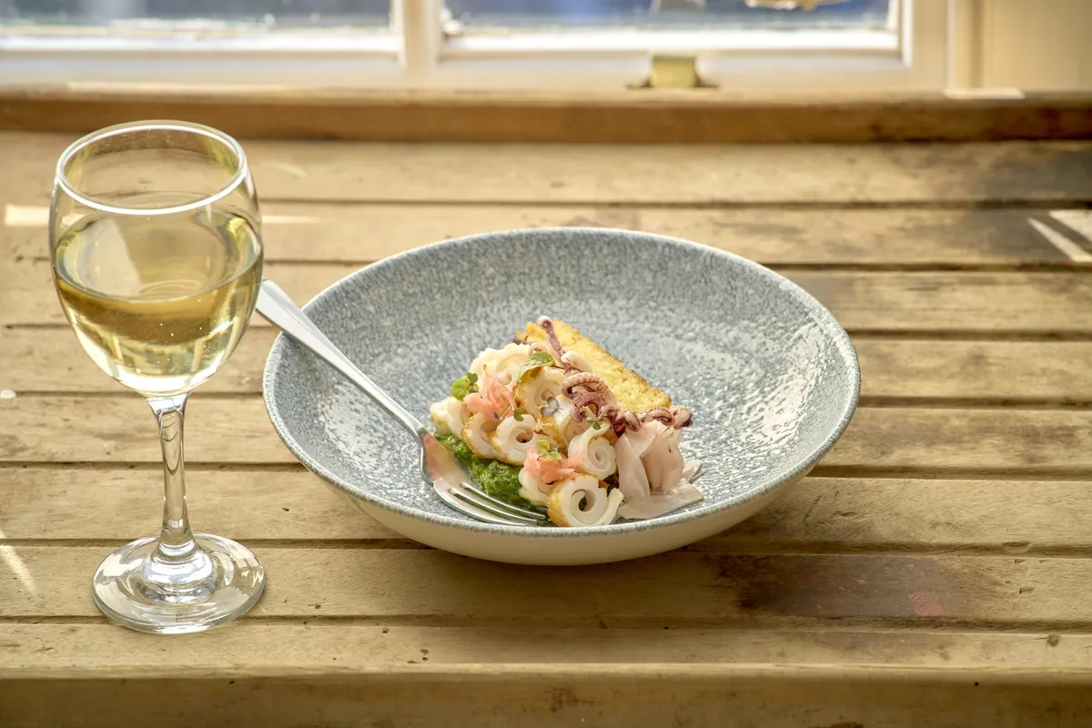 Day-boat squid in a pale ceramic bowl with herbs — Devon seafood at The Galley