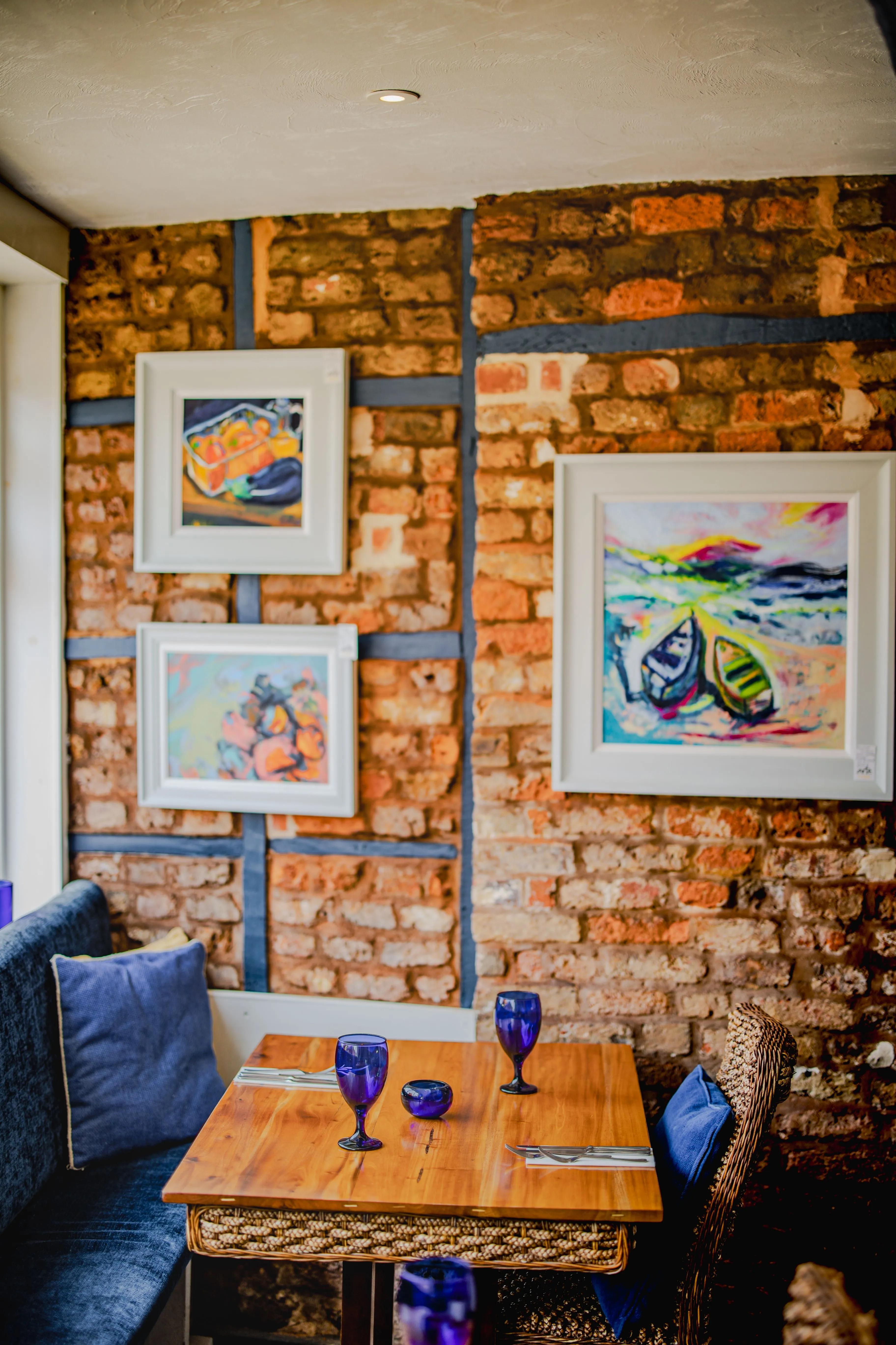 The Galley dining room — exposed brick wall with local artwork